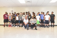 Miami Sunset Senior High School students pose for a photo with Buck Martinez, president and founder of Student ACES (bottom, left), and Mandrell Nickel (bottom, right), Miami Sunset Senior High School’s football coach, during a recent Student ACES worksho