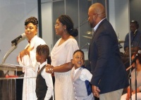 Rev. Janae Pitts-Murdock (left) addresses the congregation with her family as interim pastor at Light of the World Christian Church in Indianapolis.