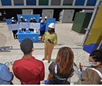 Whitney Walker, senior community relations specialist for Florida Power & Light Company (FPL), speaks of career opportunities and the importance of STEM studies while her colleagues present local students Miya Aviles, Jayden McNab, and Luke Fourie.