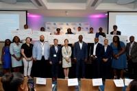 Eight recipients of the NextEra Energy Scholarship for Black Students in the Southeastern Consortium for Minorities in Engineering (SECME) proudly hold up their $20,000 college scholarship check from Florida Power & Light Company.