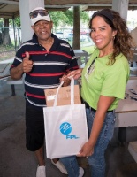 FPL Customer Service Communications Manager Bianca Soriano (right) distributes hurricane preparedness meal kits to senior Saro Leonard (left) at Allapattah Community Action Center.