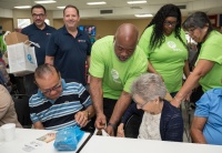 FPL Inside Sales Representative Jeremy Snell (center) distributes hurricane preparedness meal kits to seniors at Allapattah Community Action Center. It’s part of FPL’s commitment to power strong communities.