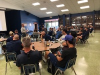 Buck Martinez, founder of the Student ACES nonprofit, speaks to a group of about 55 coaches Aug. 8, 2019 at Christopher Columbus High School, of which he is an alumnus.